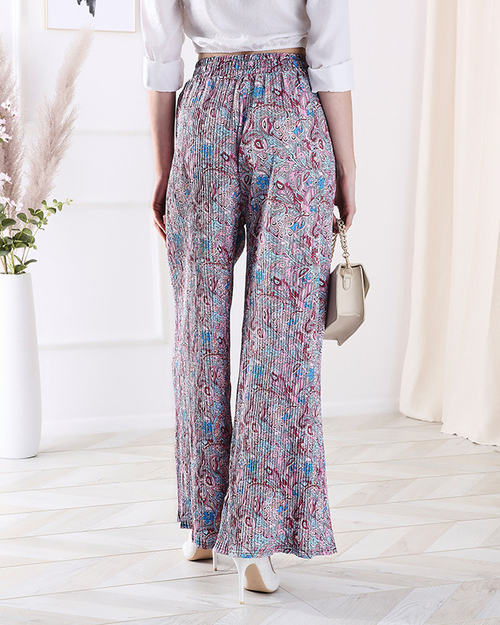 Жіночі брюки з візерунком на широких штанинах синього кольору - Одяг