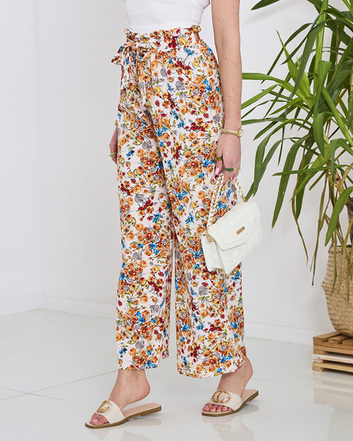 Жіночі білі штани палаццо з помаранчевими квітами - Одяг