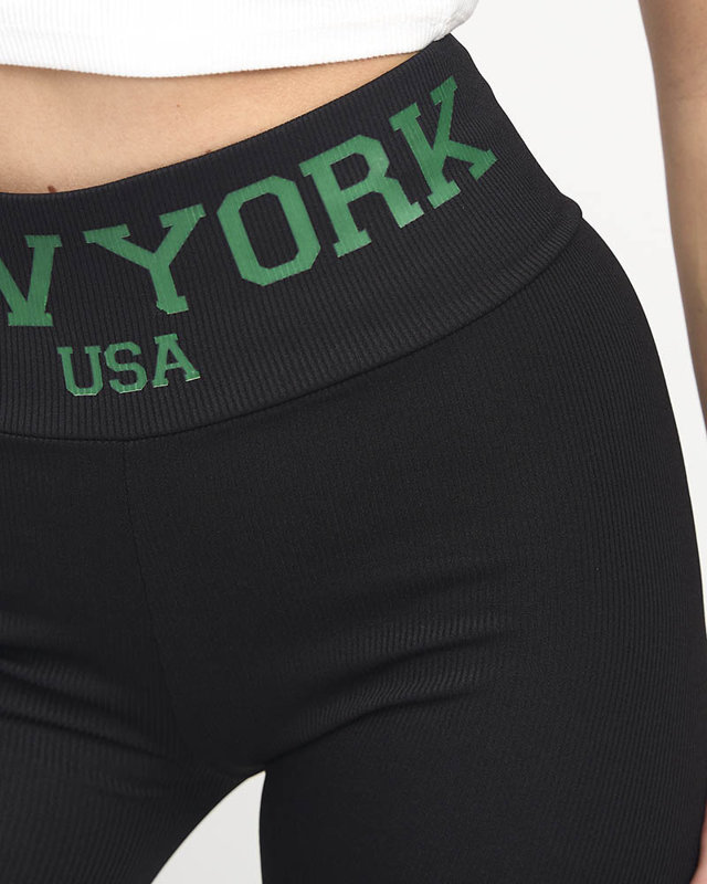 Schwarz gestreifte Damen-Leggings mit grünen Zeichen - Bekleidung