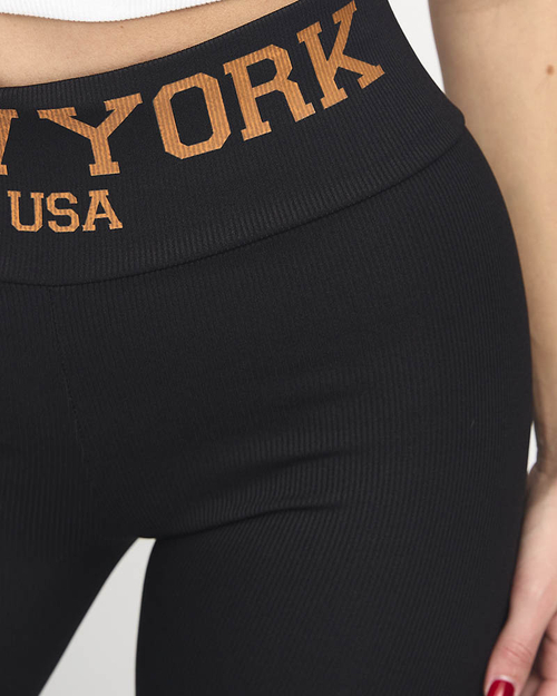 Чорні легінси в рубчик із помаранчевими написами