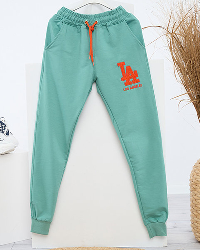 Grüne Damen-Jogginghose mit farbigem Aufnäher - Kleidung