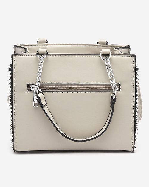 Біла жіноча сумочка з плетеною вставкою