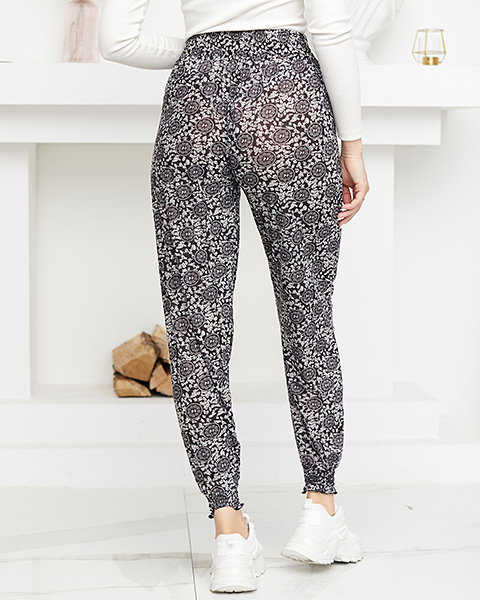 Чорно-білі жіночі штани з принтом - Одяг