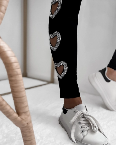 Schwarze Damen-Leggings mit herzförmigen Ausschnitten und Zirkonen- Bekleidung