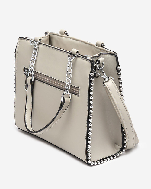 Біла жіноча сумочка з плетеною вставкою