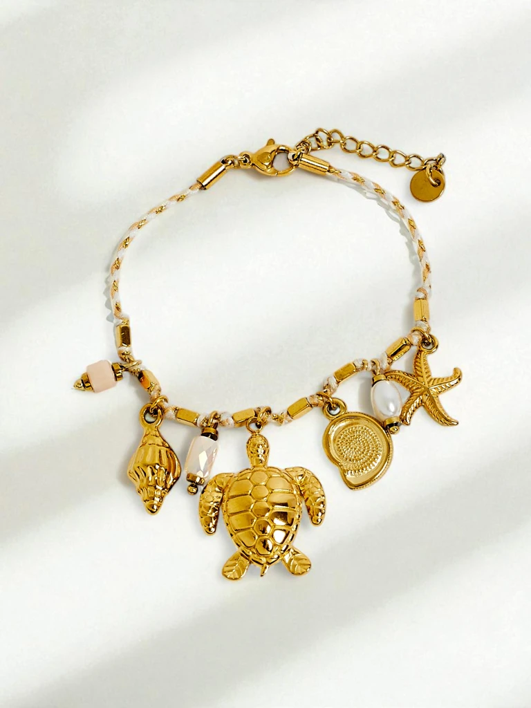 Armband Tartaros Aurea – Meeresinspiration mit Schildkröten- und Muschelmotiven