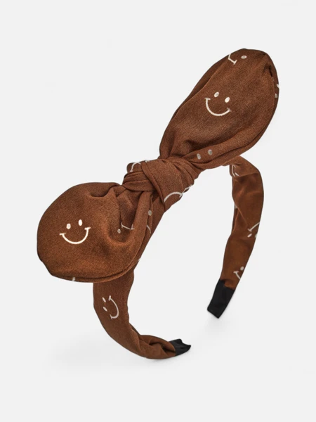 Royalfashion Kinderhaarband mit Schleife und Print aus lachenden Gesichtern