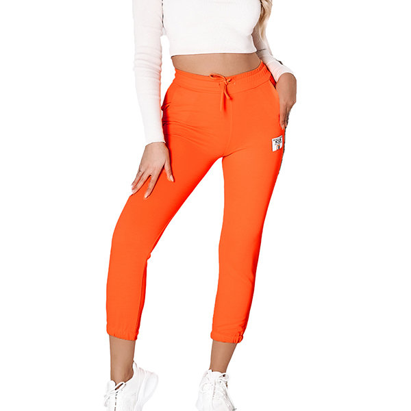 Неоново-помаранчеві жіночі спортивні штани з нашивкою - Одяг